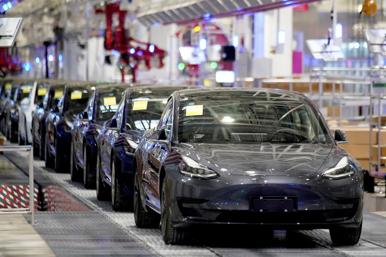 FILE PHOTO: FILE PHOTO: Tesla China-made Model 3 vehicles are seen during a delivery event at its factory in Shanghai