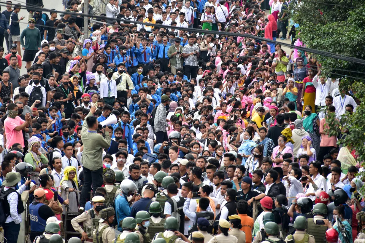 Demonstrators attend a protest march to demand an end to the latest spurt of ethnic violence, in Imphal