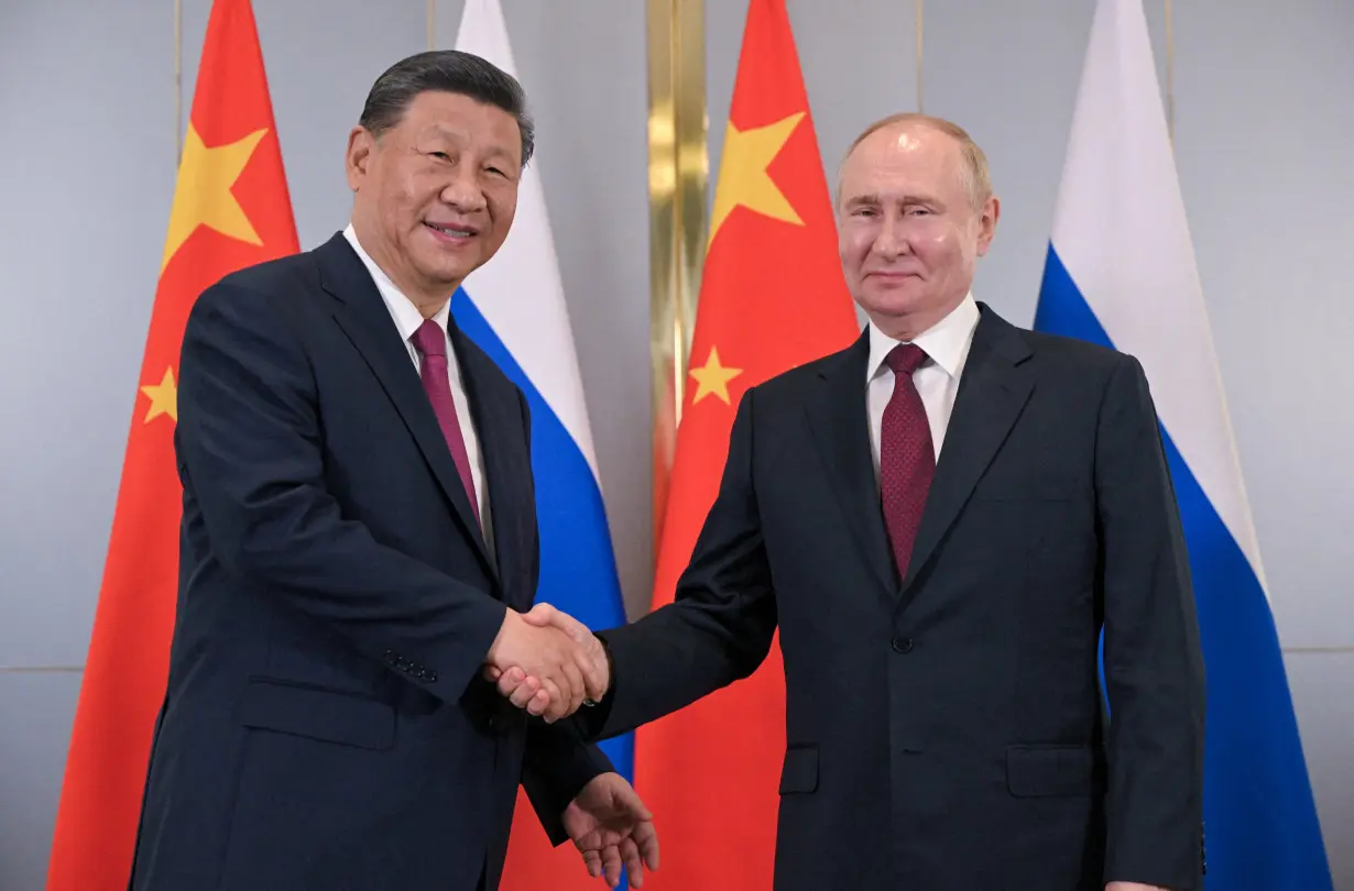 Russian President Putin and Chinese President Xi meet in Astana