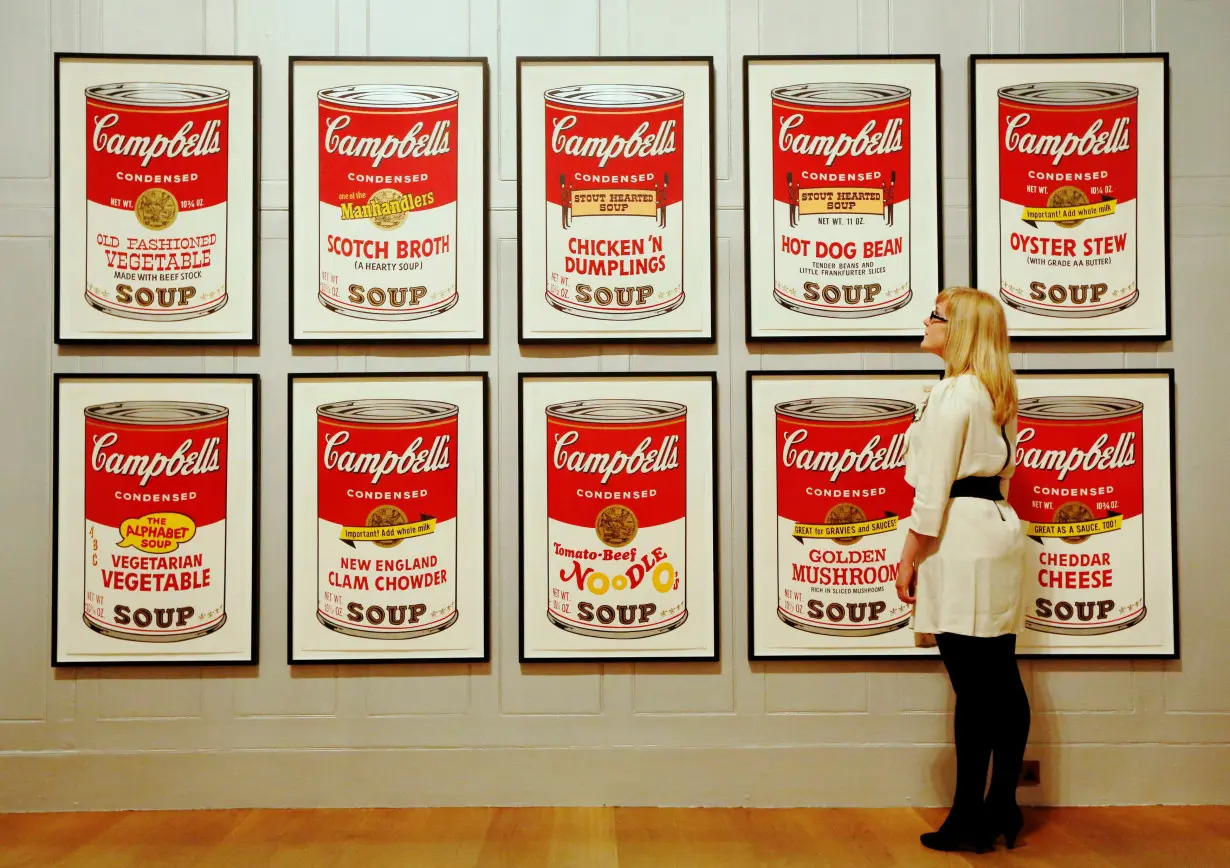 FILE PHOTO: Gallery employee Maddy Adeane poses with Andy Warhol's 