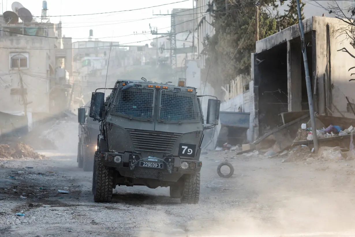 Israeli military vehicles operate during an Israeli raid in Tulkarm