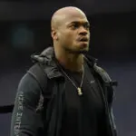 Judge orders former NFL star Adrian Peterson to turn over assets to pay $12M debt