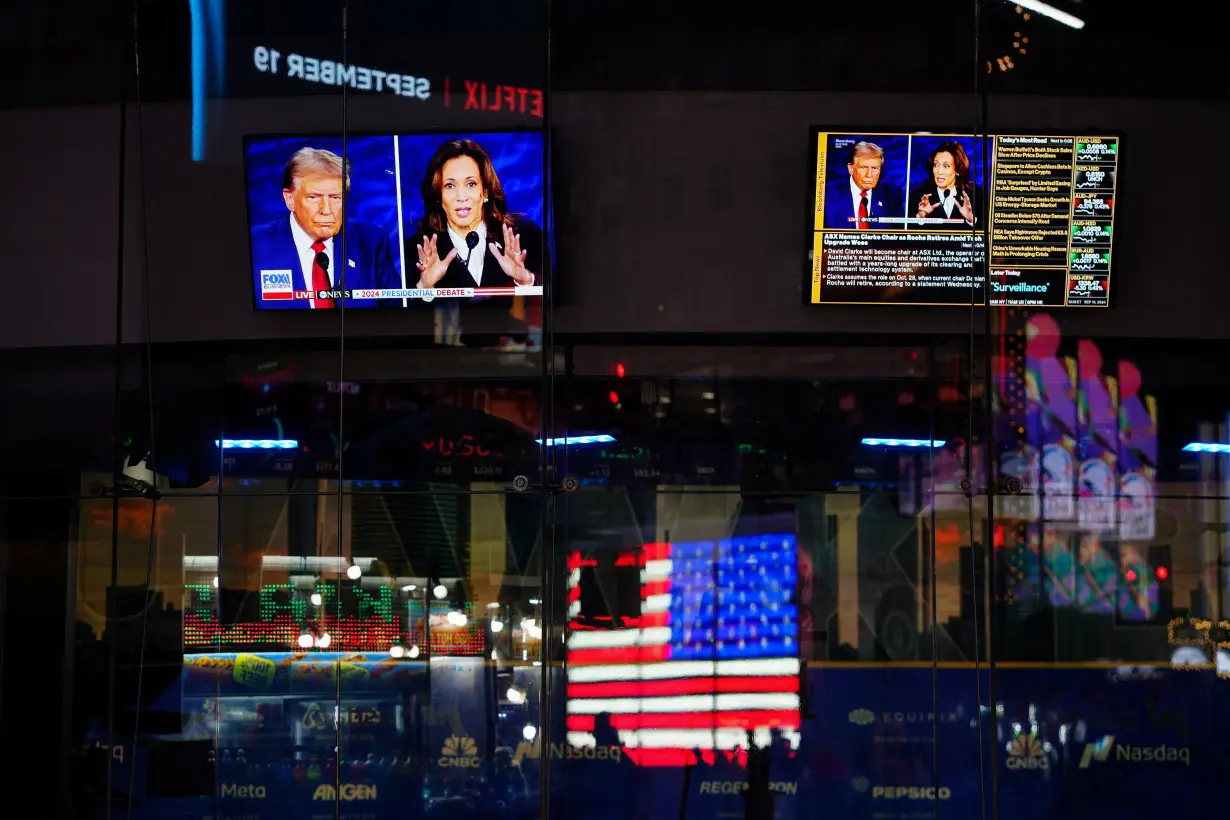 People watch the presidential debate between Trump and Harris, in New York