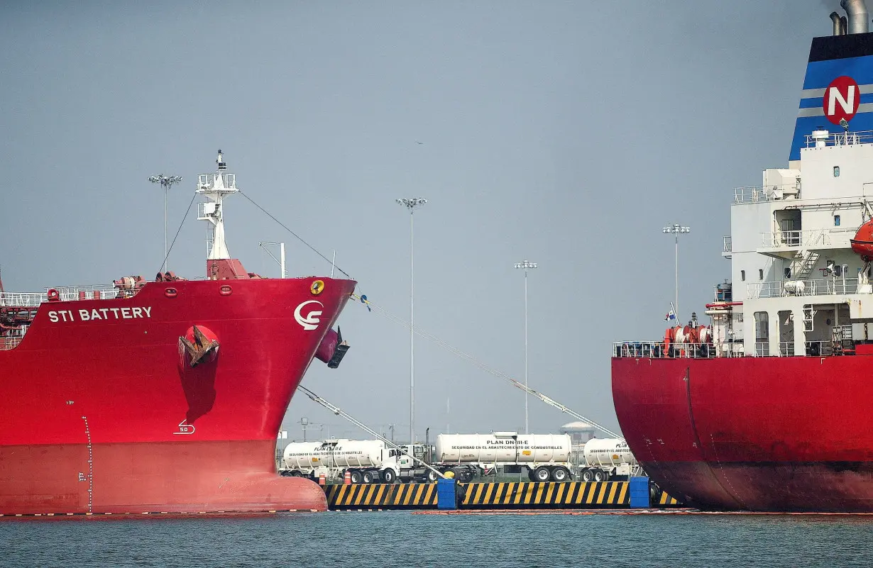 FILE PHOTO: Tanker trucks are seen among oil tankers docked at the port of Tuxpan