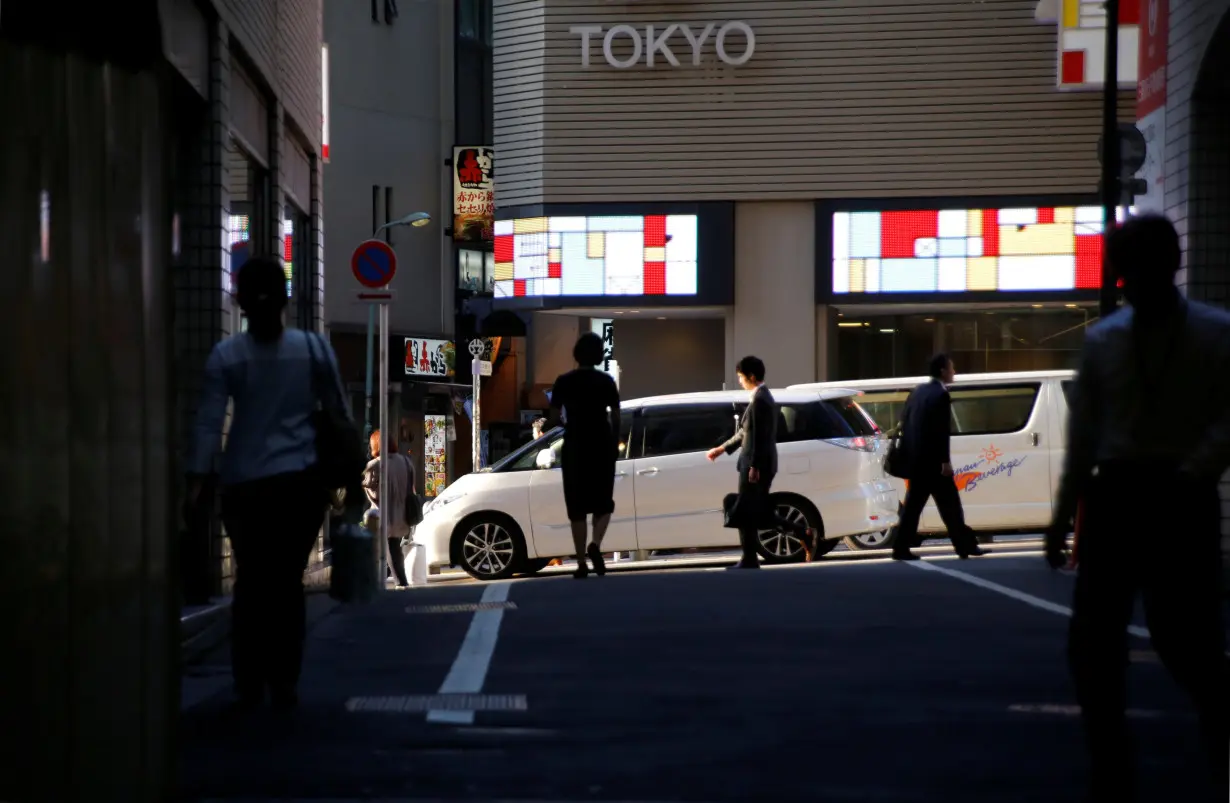 People walk at a business district in central Tokyo