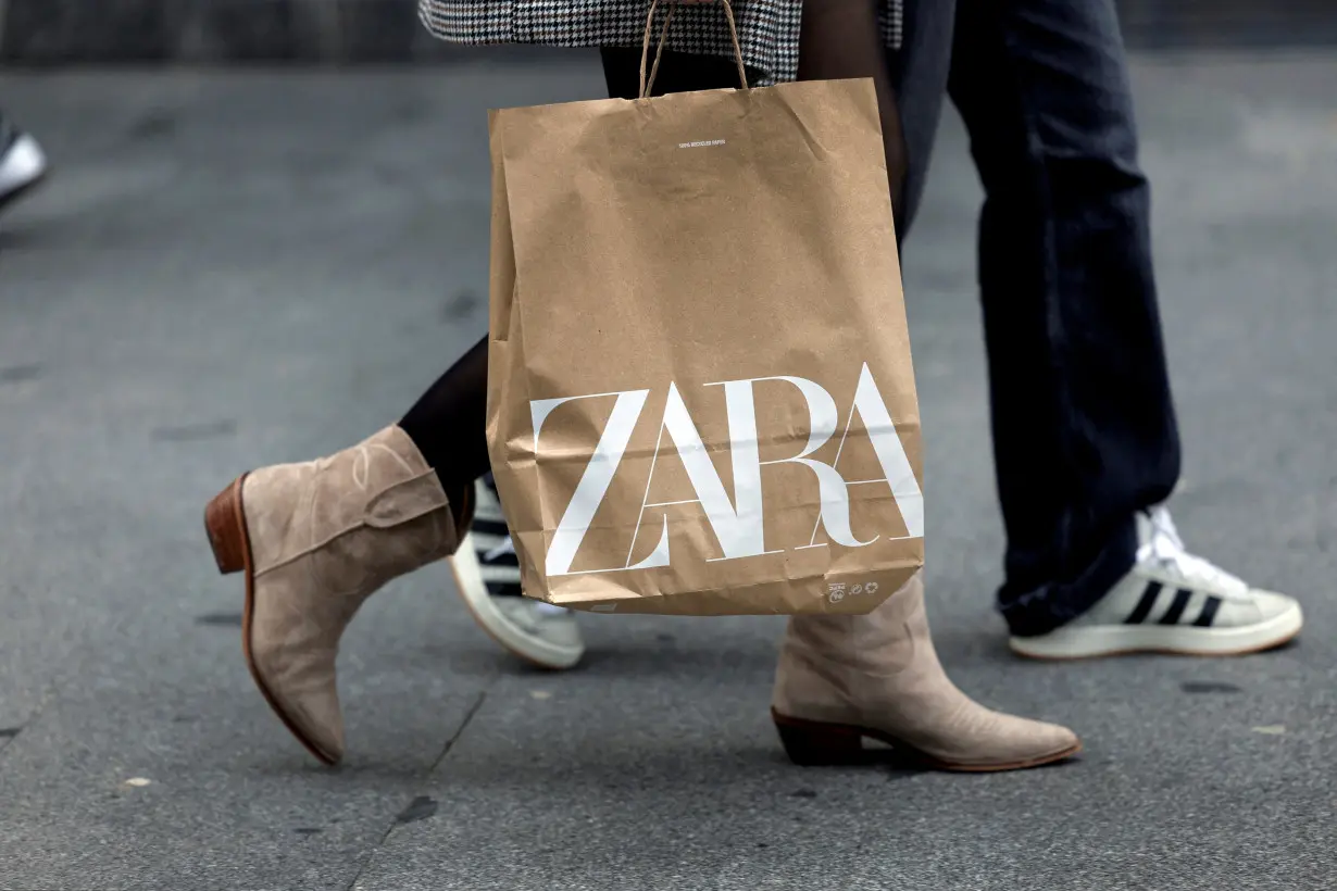 FILE PHOTO: A woman carries a bag from Spanish multinational retail clothing chain Zara, in Bilbao