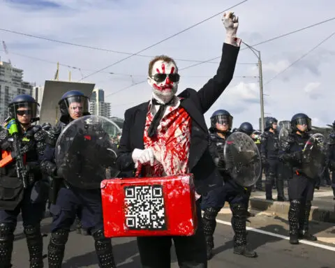 Anti-war protesters in Australia clash with police outside a weapons convention