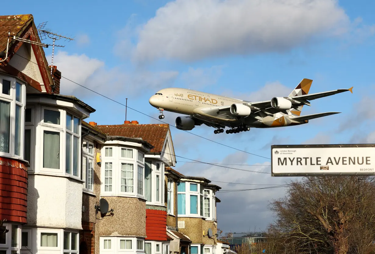 An Etihad Airways plane lands at Heathrow during Storm Isha in London.