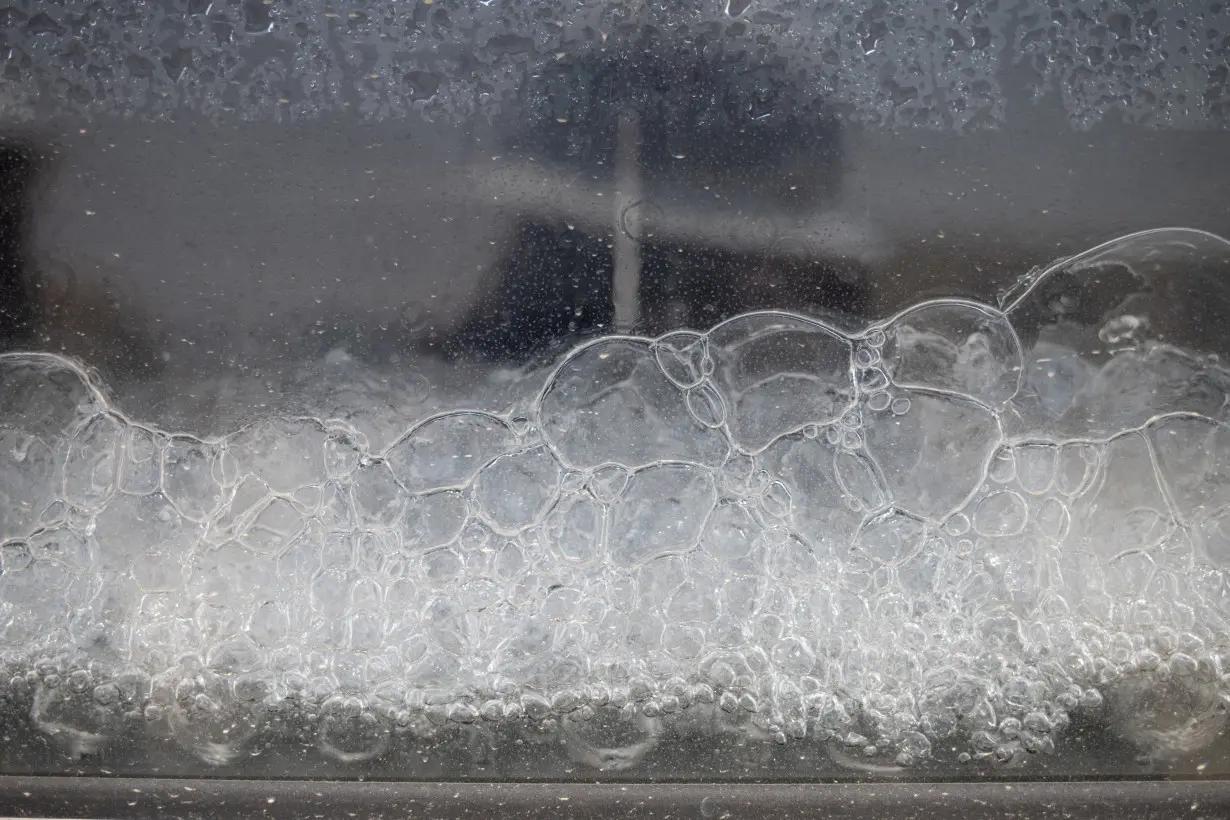 Air bubbles rise through treated water at a wastewater treatment project in Texas