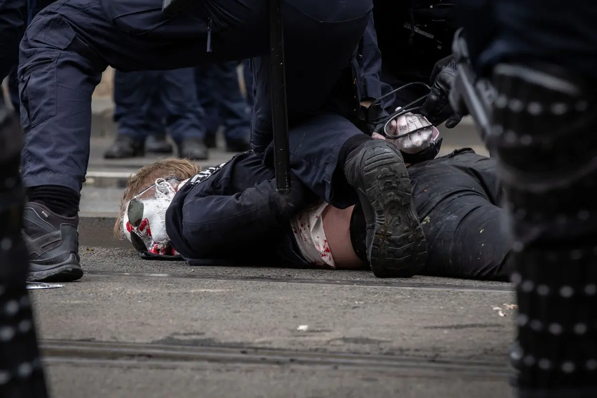 A protester is detained by Victoria Police on Spencer Street on September 11, in Melbourne.