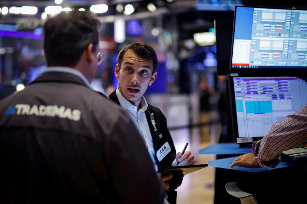 Traders work on the floor of the NYSE in New York