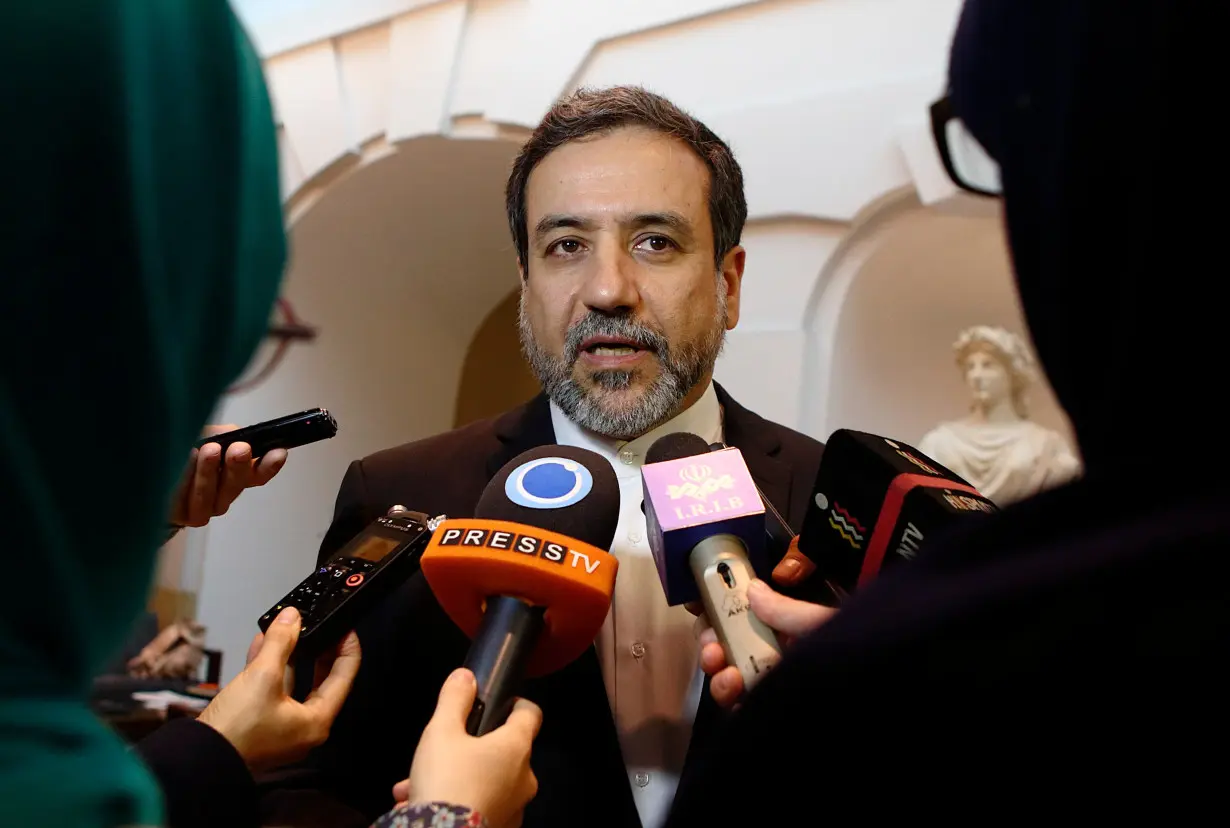 Iran's top nuclear negotiator Araqchi talks to journalists after meeting senior officials from the United States, Russia, China, Britain, Germany and France in a hotel in Vienna