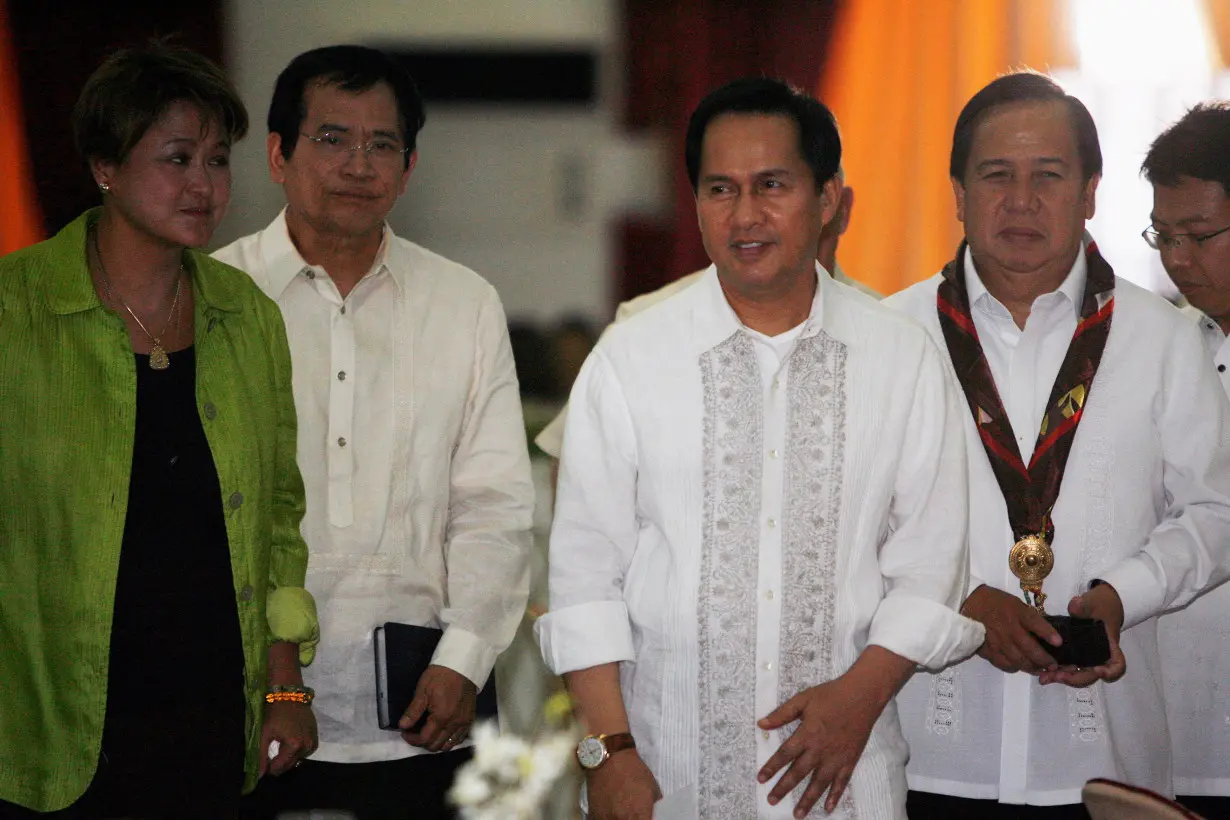 FILE PHOTO: International evangelist Pastor Apollo Quiboloy (2nd R) walks with presidential candidates attending his 60th birthday celebration in Davao City