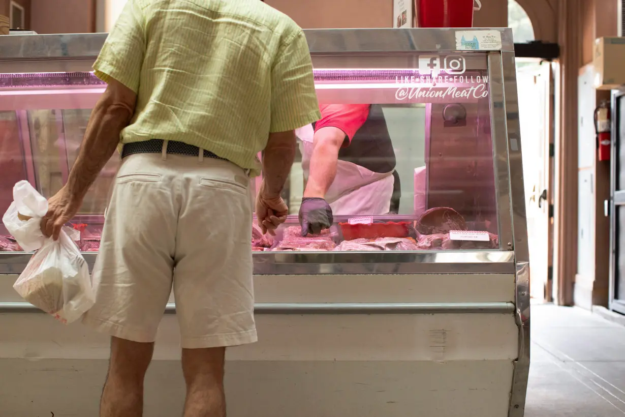 People shop for groceries at Eastern Market in Washington