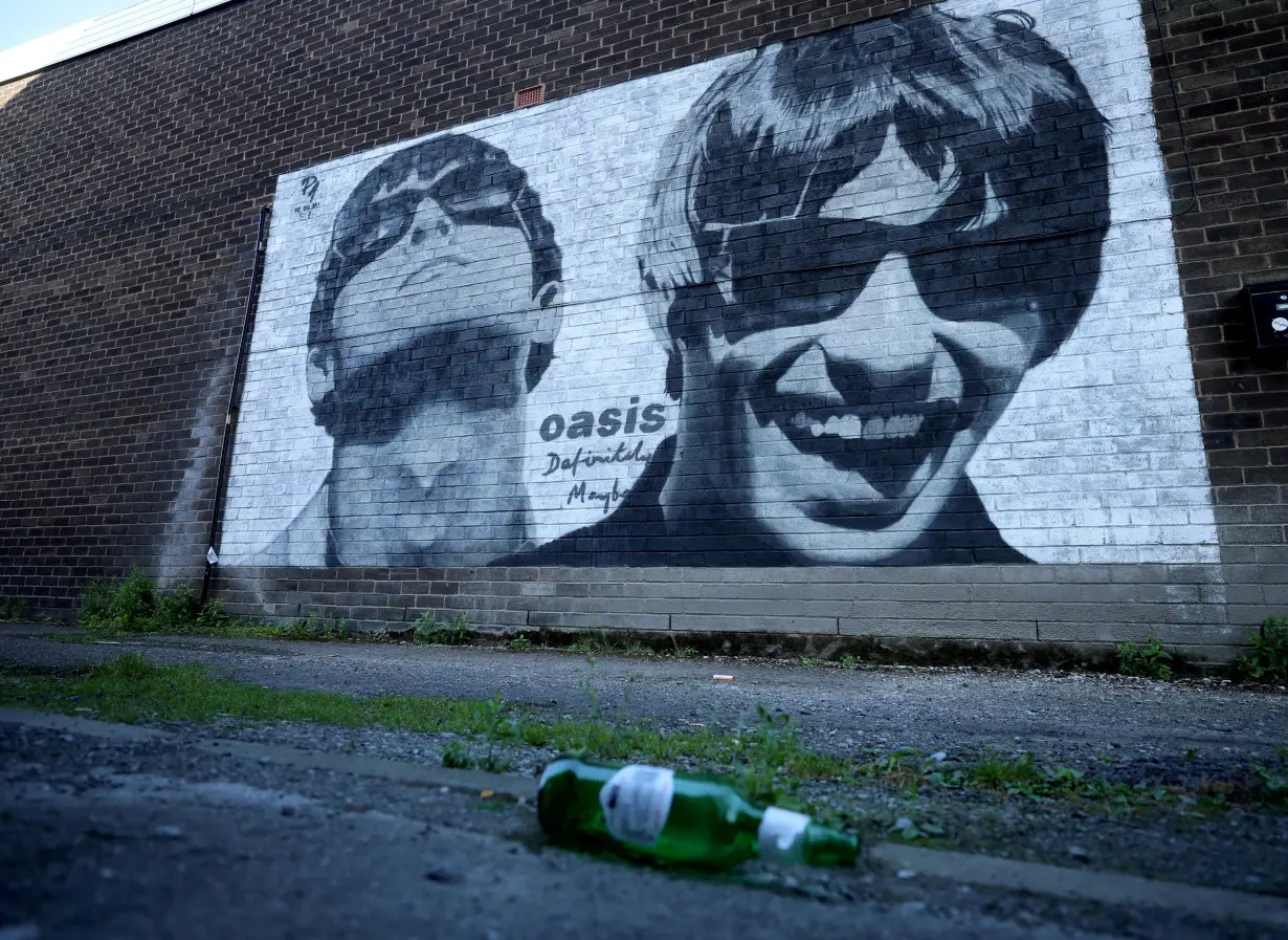 FILE PHOTO: A view of a mural of Oasis band members Liam and Noel Gallagher by artist Pic.One.Art on the side of Sifters record shop in the Burnage area of Manchester