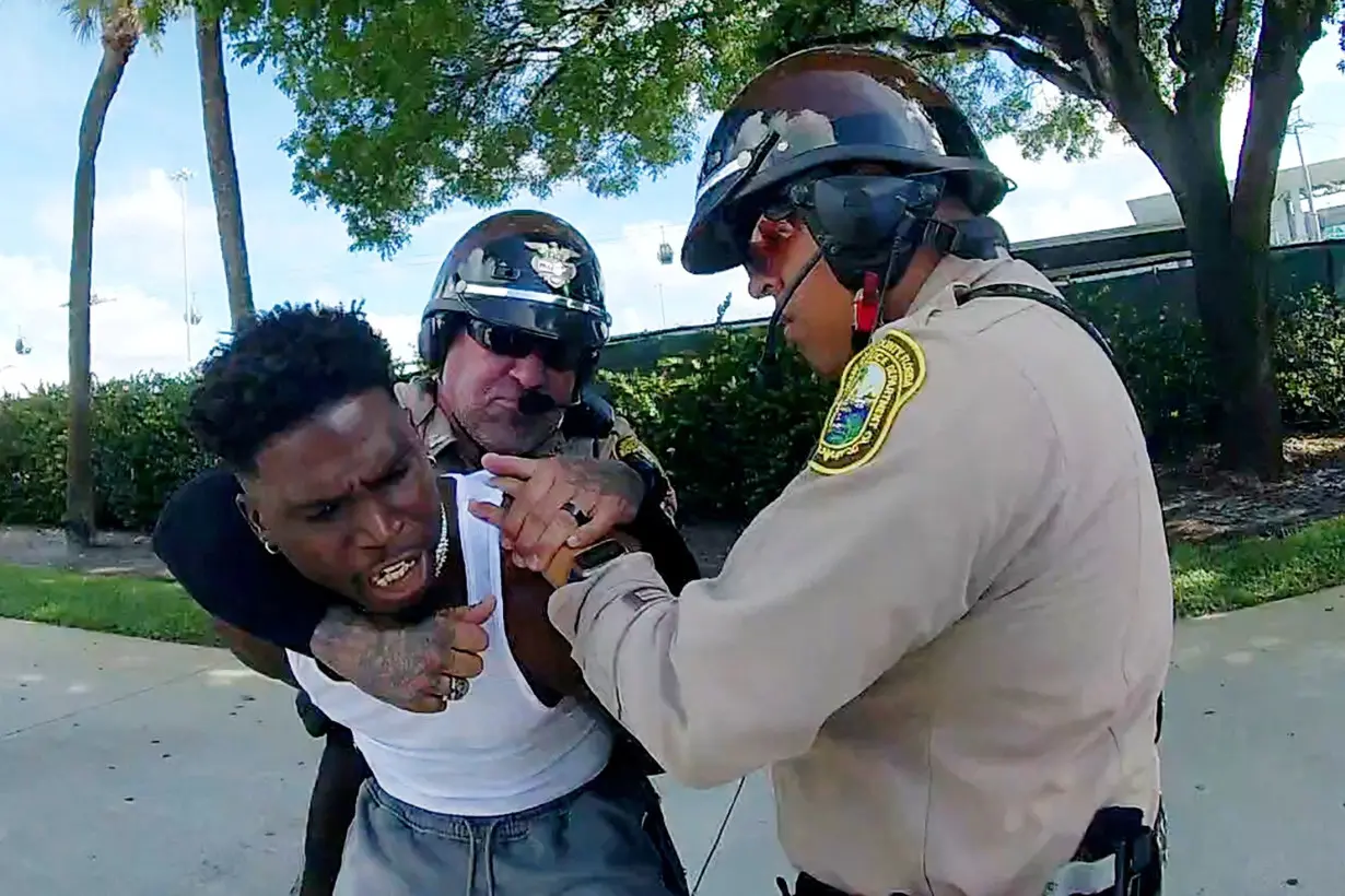 FILE PHOTO: Miami Dolphins receiver Tyreek Hill is forced from his vehicle by Miami-Dade Police Department officers in Miami