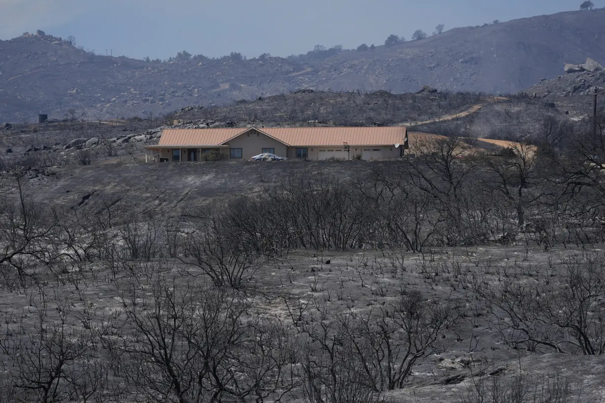 Wildfires in Southern California torch dozens of homes and force thousands to evacuate