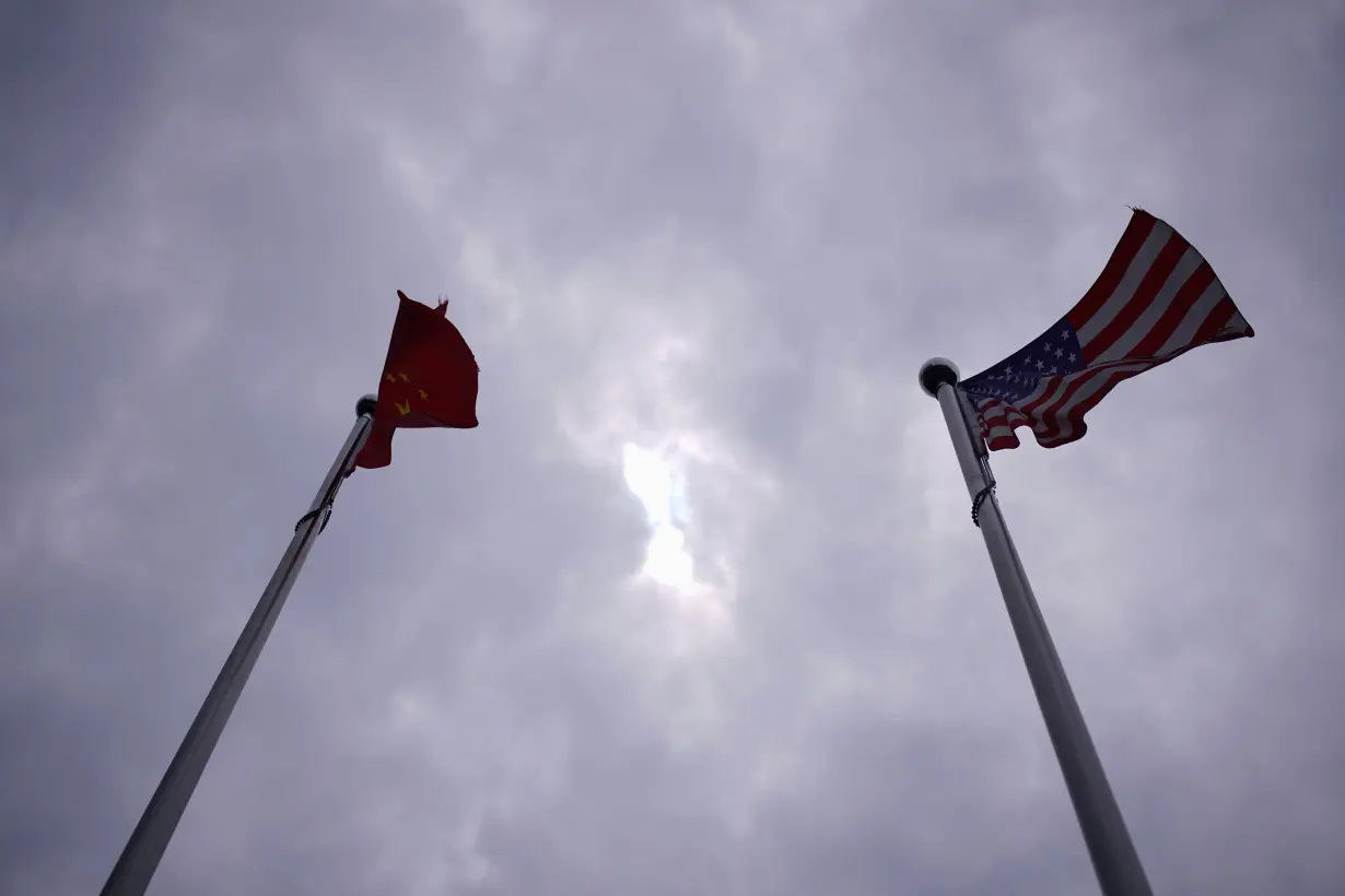 FILE PHOTO: Chinese and U.S. flags flutter in Shanghai