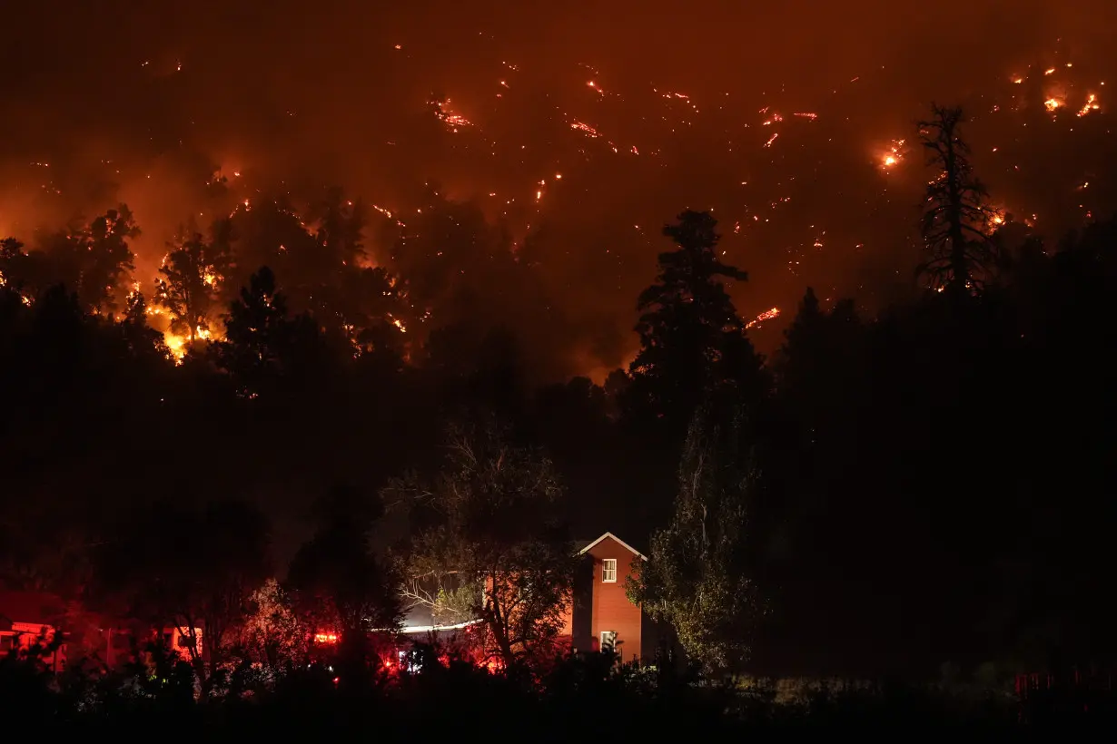 Wildfires in Southern California torch dozens of homes and force thousands to evacuate