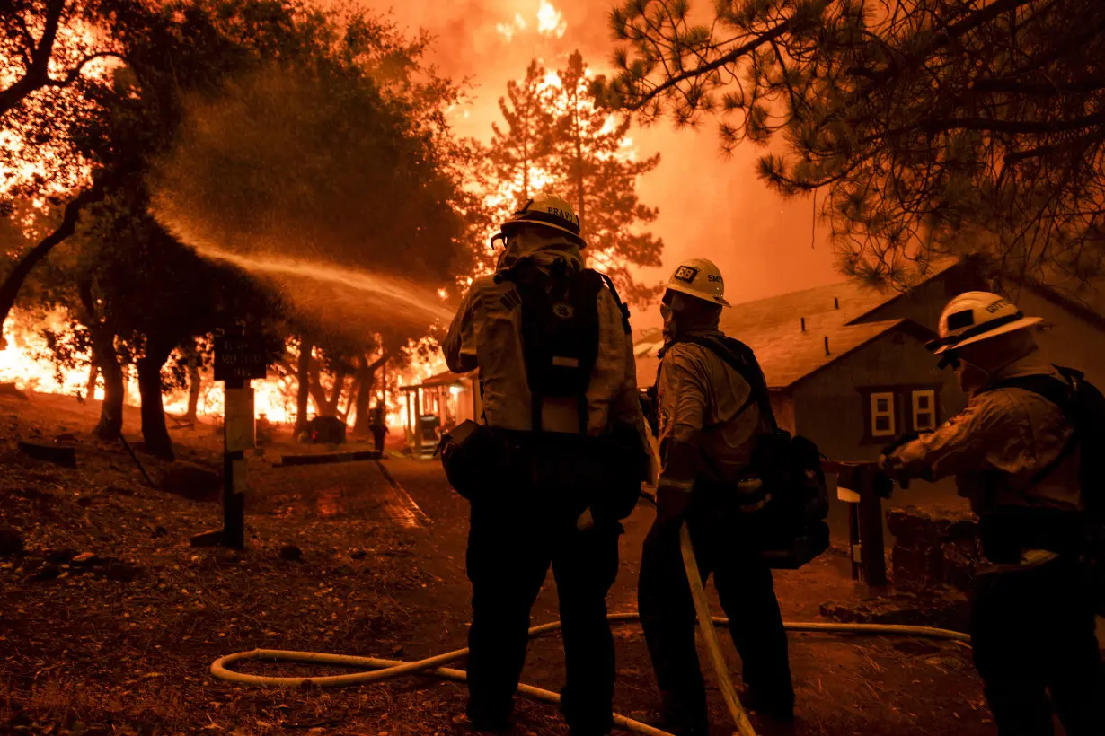 Wildfires in Southern California torch dozens of homes and force thousands to evacuate