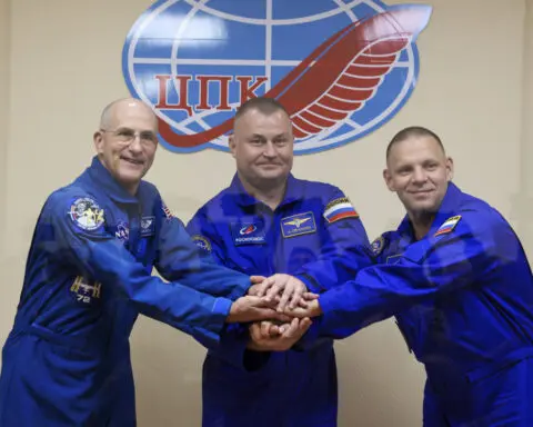 A Soyuz craft with 2 Russians and 1 American docks at the International Space Station