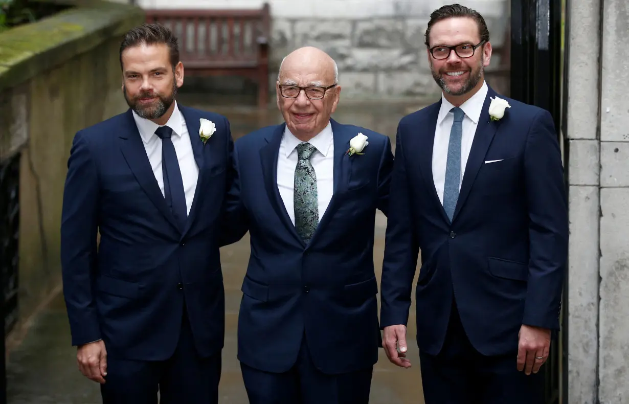 FILE PHOTO: Media Mogul Rupert Murdoch poses for a photograph with his sons Lachlan and James as they arrive at St Bride's church for a service to celebrate the wedding between Murdoch and former supermodel Jerry Hall in London