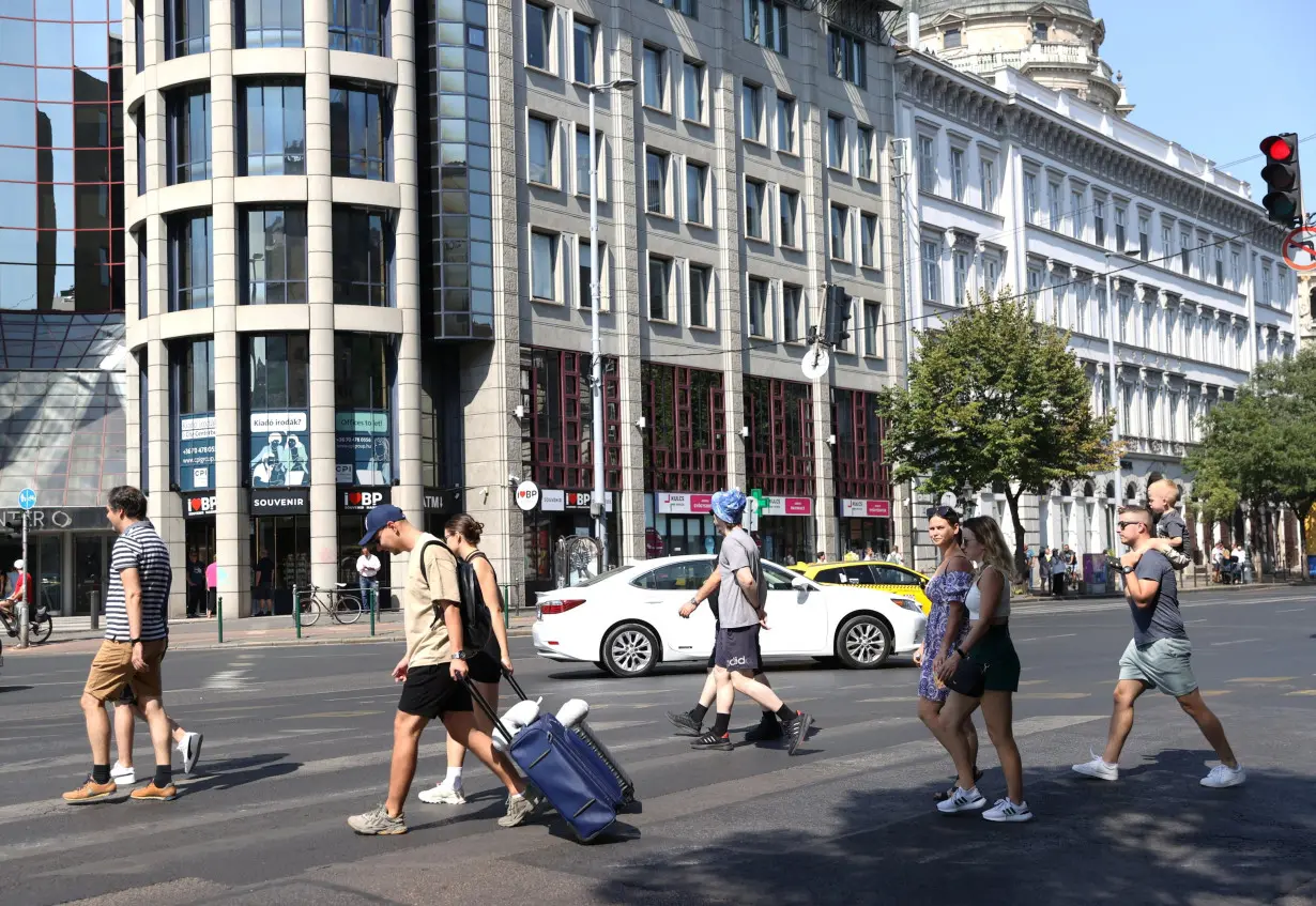 Tourists pull their suitcases in downtown Budapest