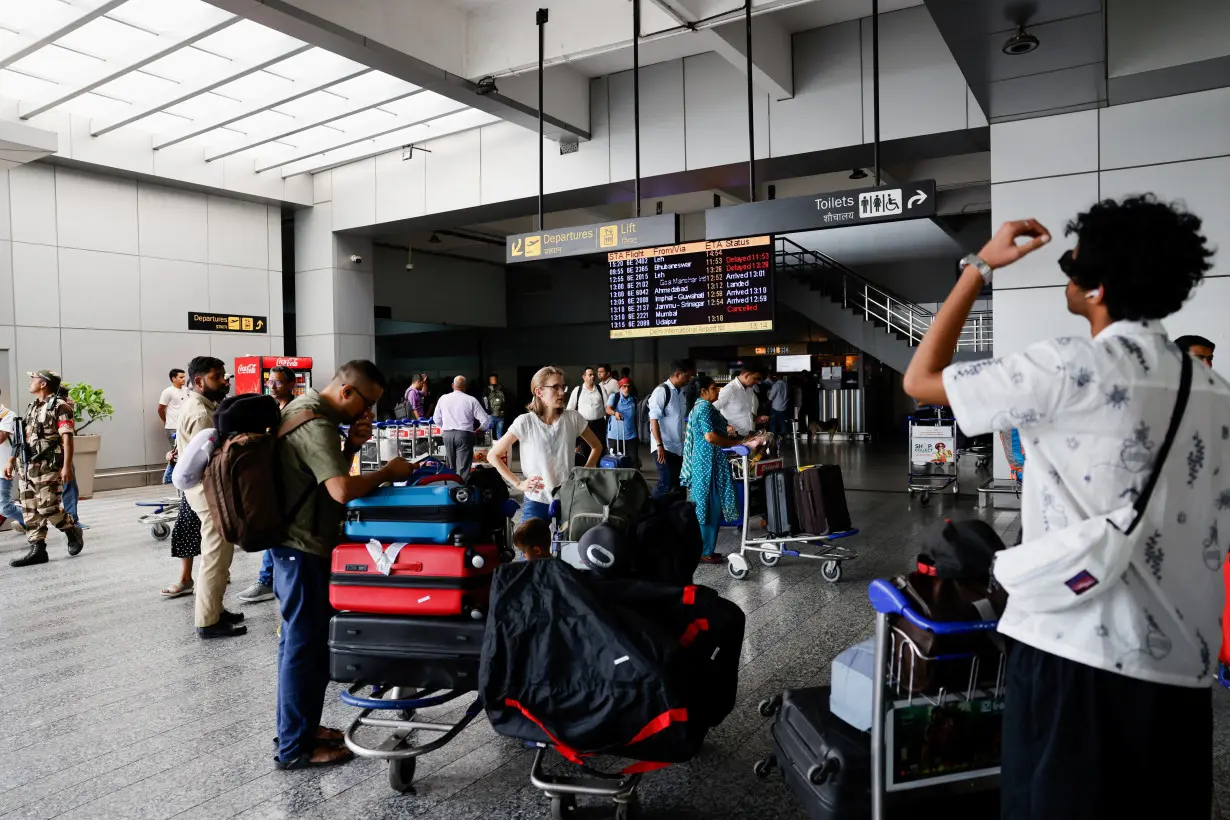 Passengers wait at Terminal 2 of Indira Gandhi International Airport in New Delhi