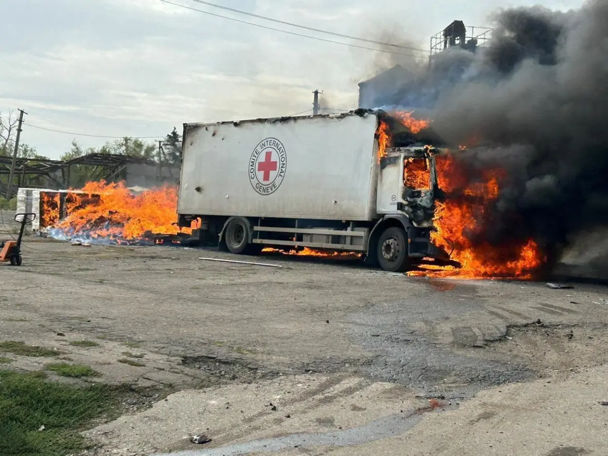 Cargo truck of the International Committee of the Red Cross burns after a Russian military strike in the village of Viroliubivka near a front line in Donetsk region