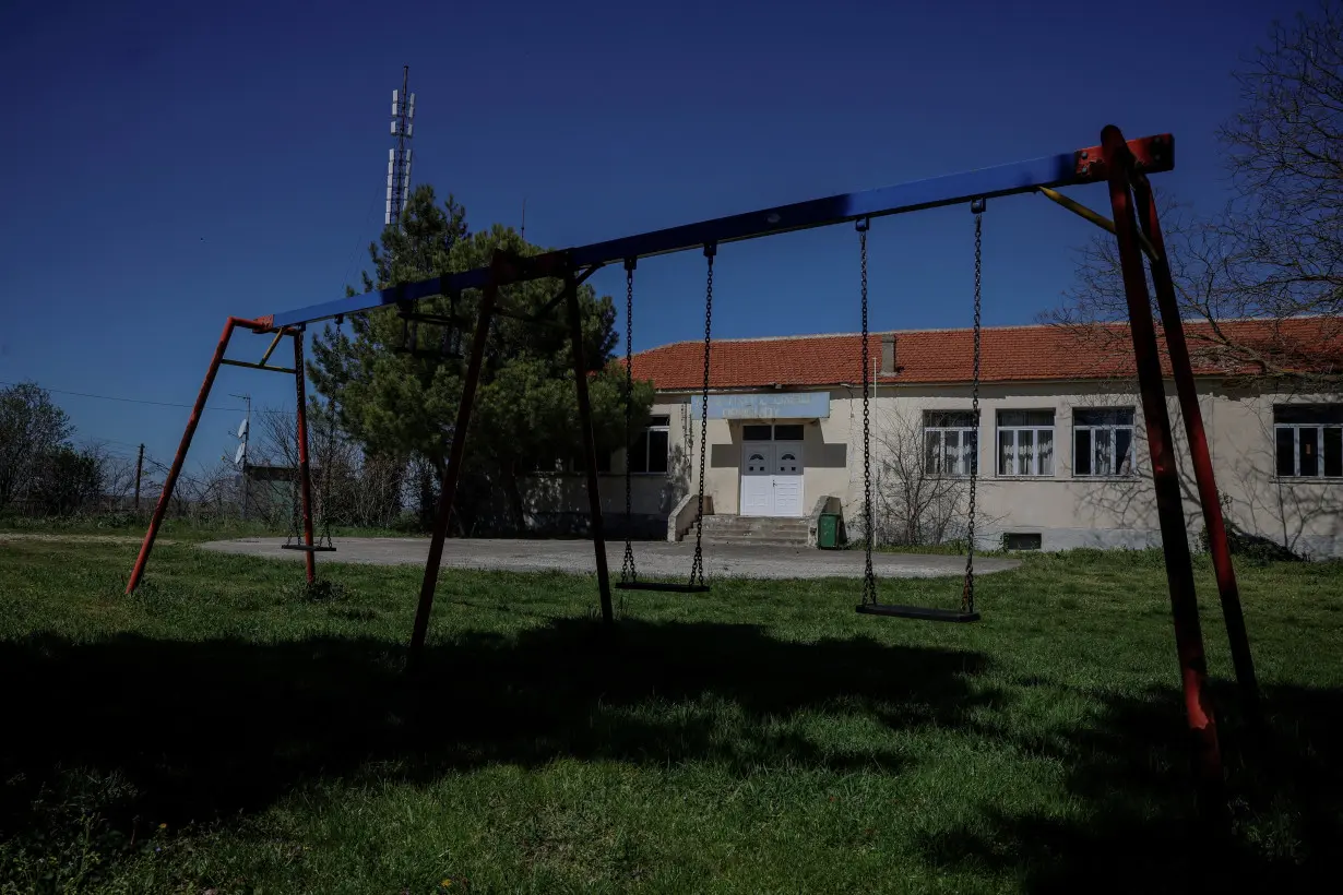 FILE PHOTO: Swings are seen outside the closed school in the village of Ormenio