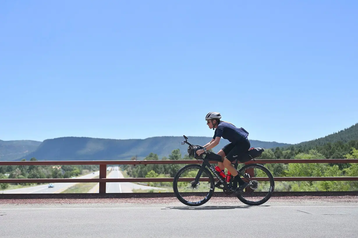 Lael Wilcox crosses a bridge over Interstate 40 near Glorieta, New Mexico.