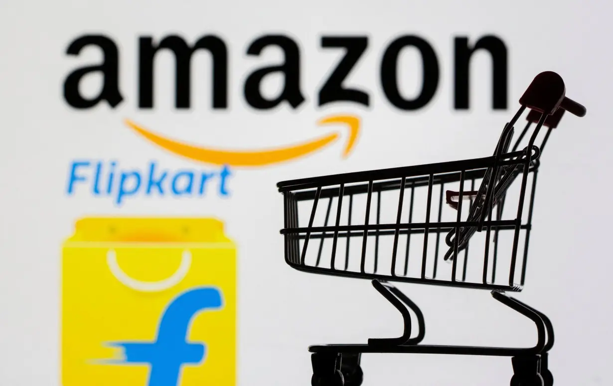 FILE PHOTO: Small toy shopping cart is seen in front of displayed Amazon and Flipkart logos in this illustration