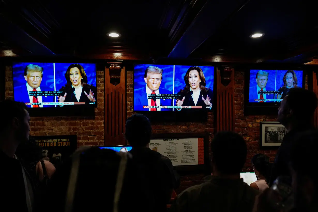 People watch the presidential debate between Trump and Harris, in New York