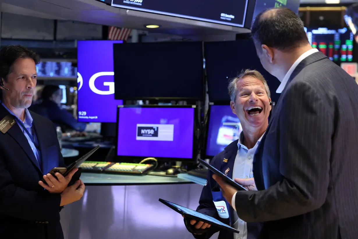 Traders work on the floor of the NYSE in New York