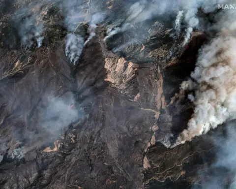 Los Angeles wildfires slow, still threaten suburbs