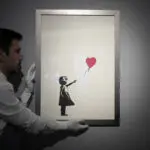 2 men charged with stealing a famous Banksy image from a London art gallery