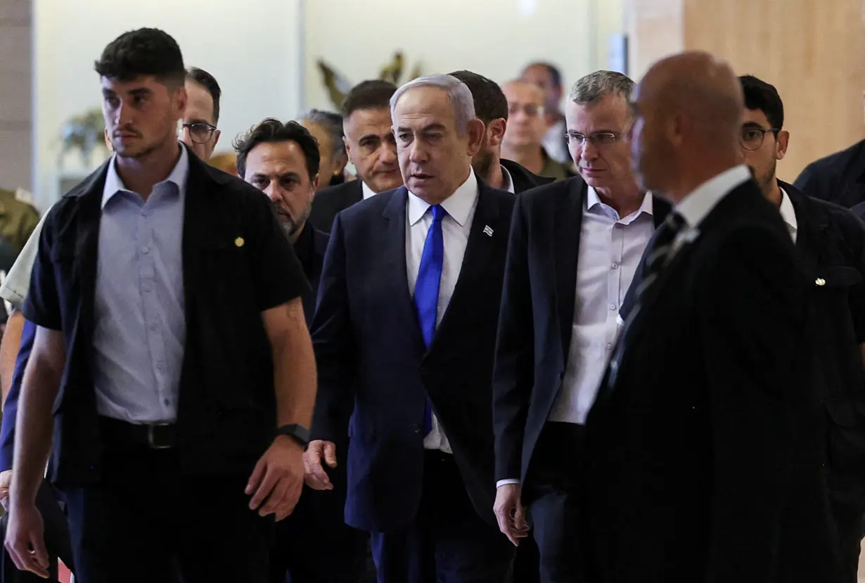 Israeli Prime Minister Netanyahu arrives to his Likud party faction meeting at the Knesset,in Jerusalem