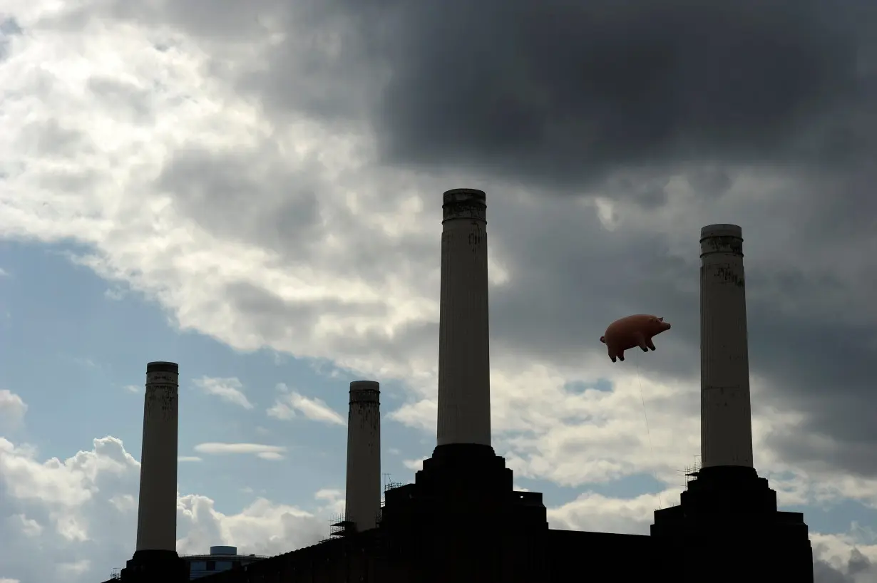 An inflatable pink pig flies above Battersea Power Station in London