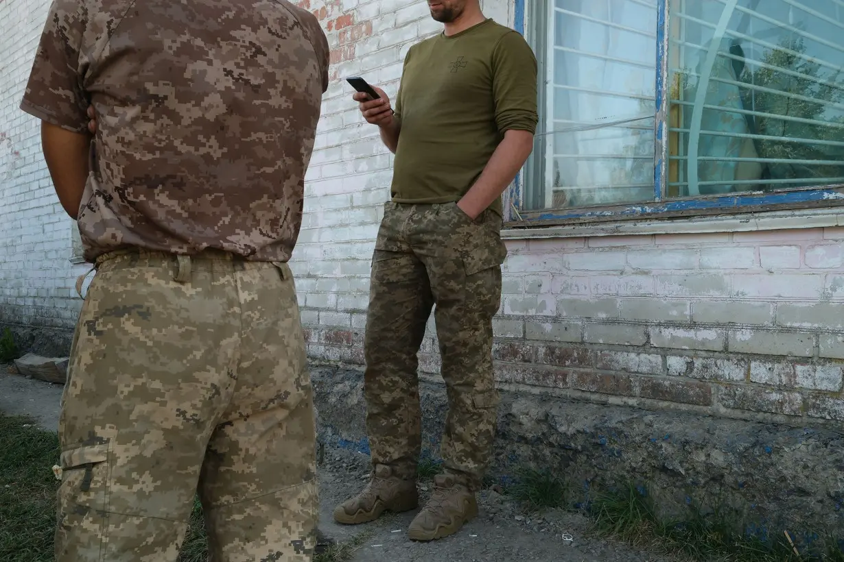 A group of Ukrainian soldiers rest in a village near the Russian border after taking part in Ukraine's operation in Kursk.