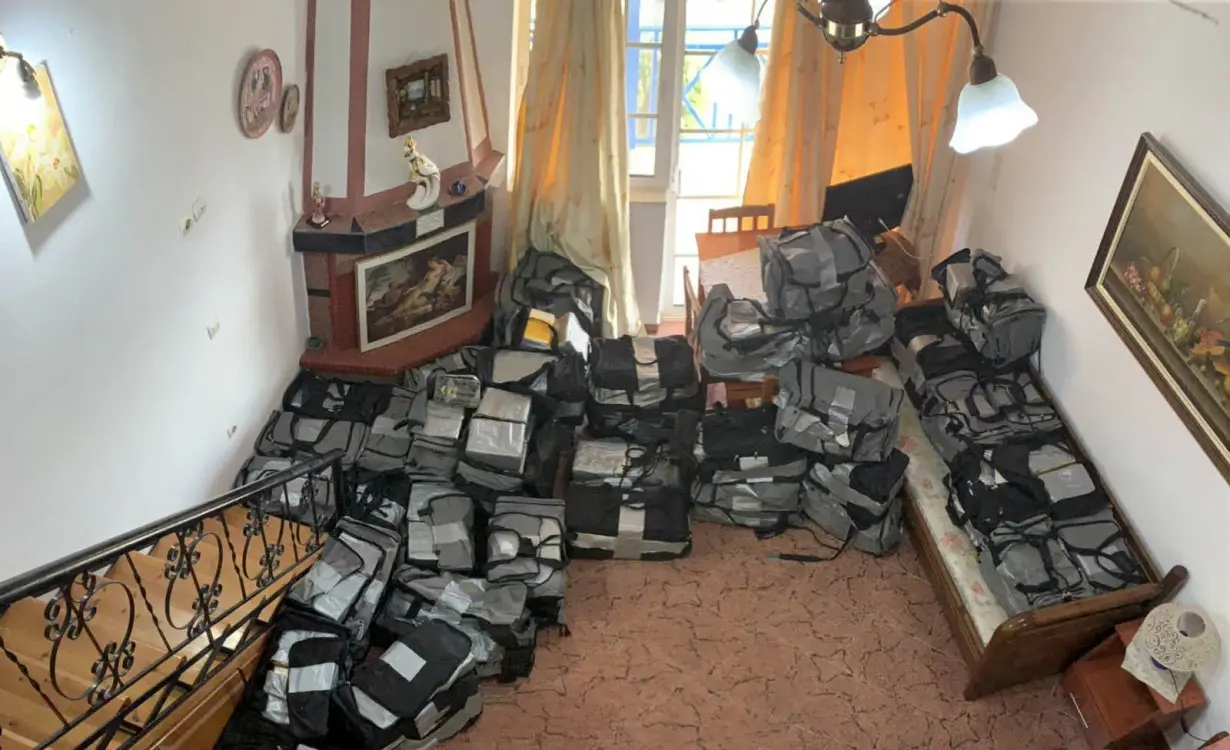 Travel bags filled with cocaine packages are seen inside an apartment after a police raid in Astakos