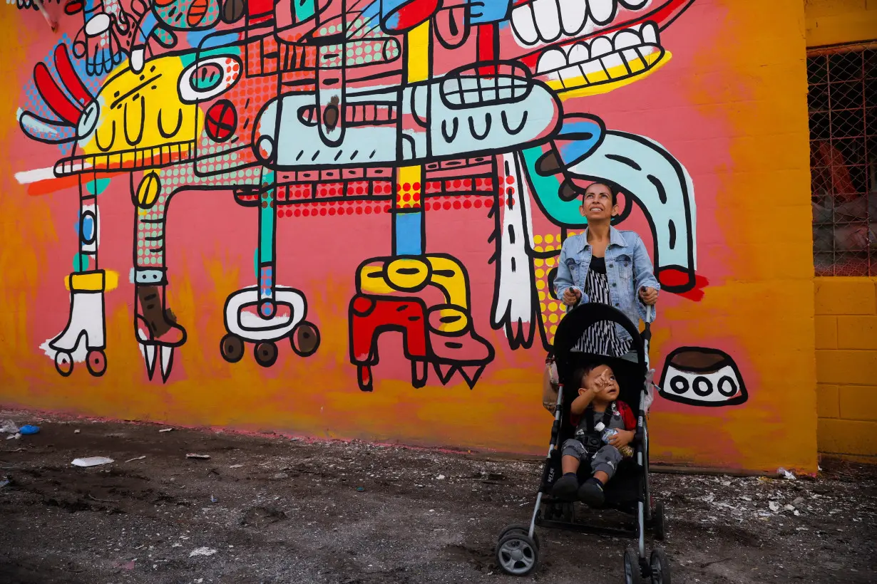 El Salvador muralists paint over traces of violence in San Salvador neighborhood