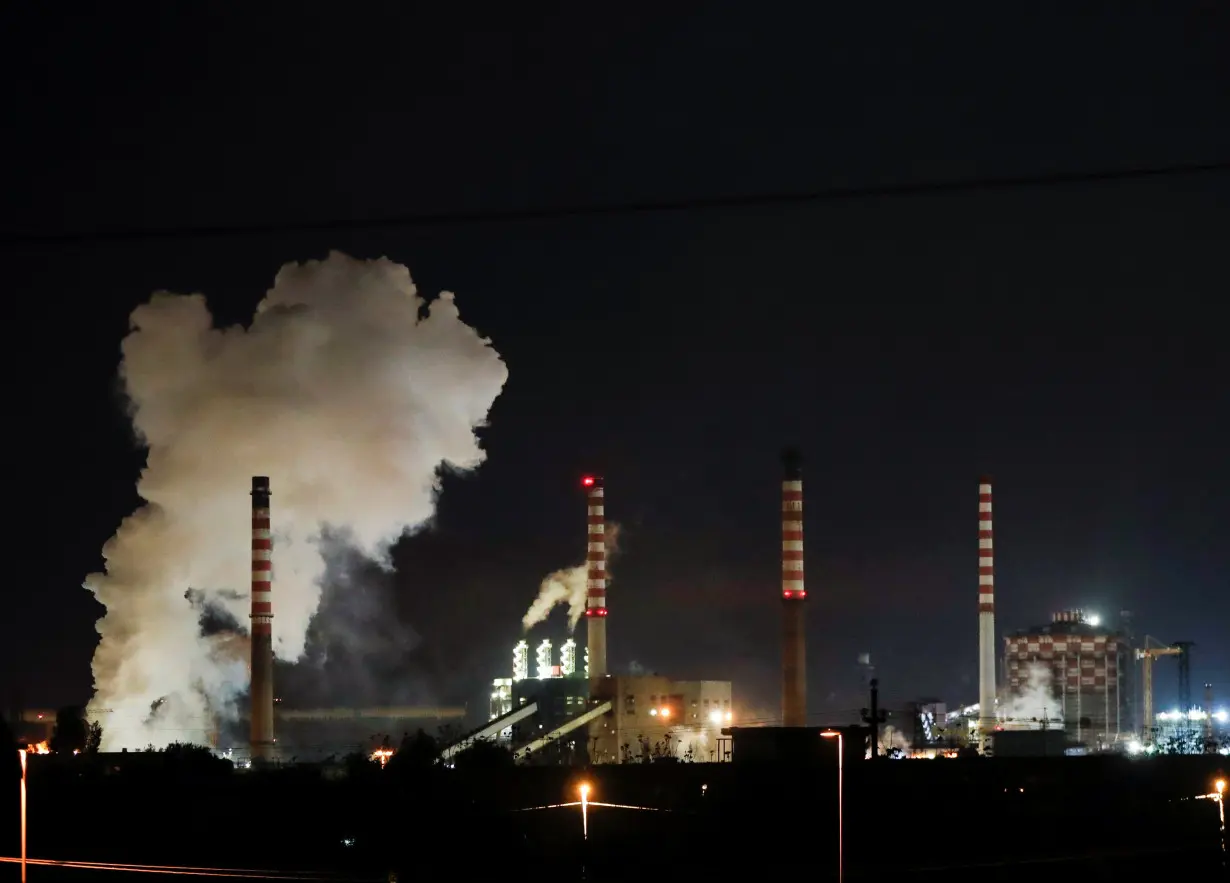 Steam comes out of the chimneys of Ilva steel plant in Taranto