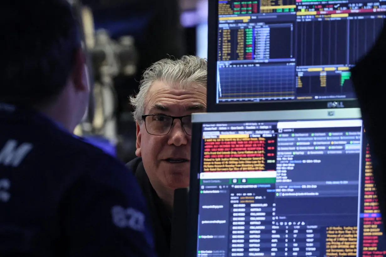 Traders work on the floor of the NYSE in New York