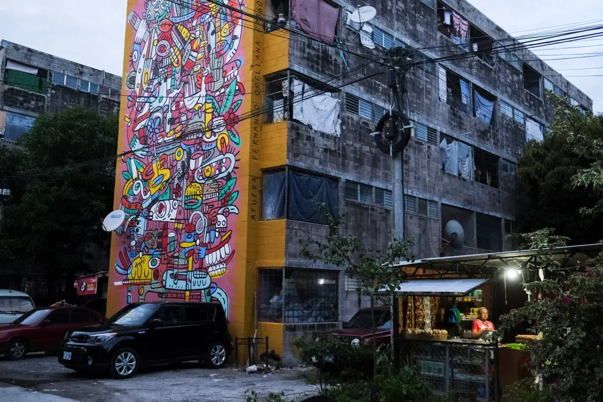 El Salvador muralists paint over traces of violence in San Salvador neighborhood