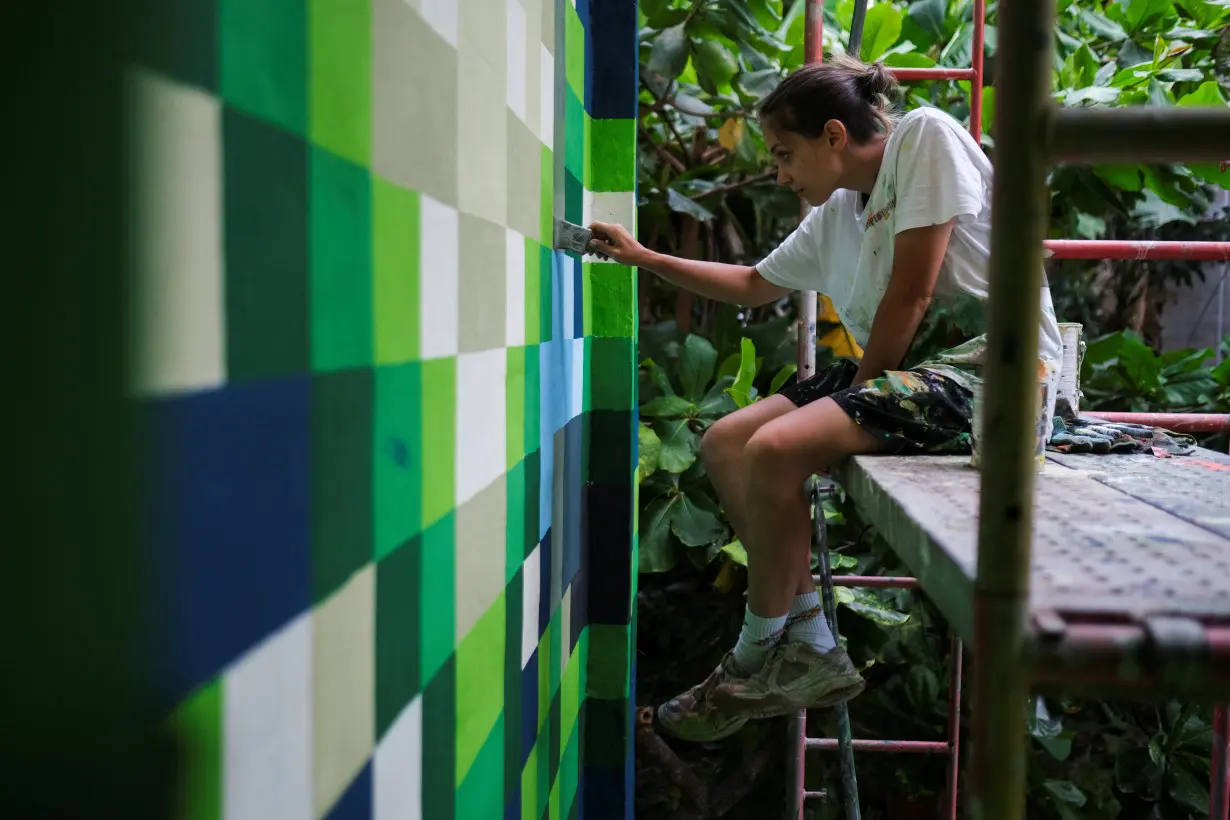 El Salvador muralists paint over traces of violence in San Salvador neighborhood