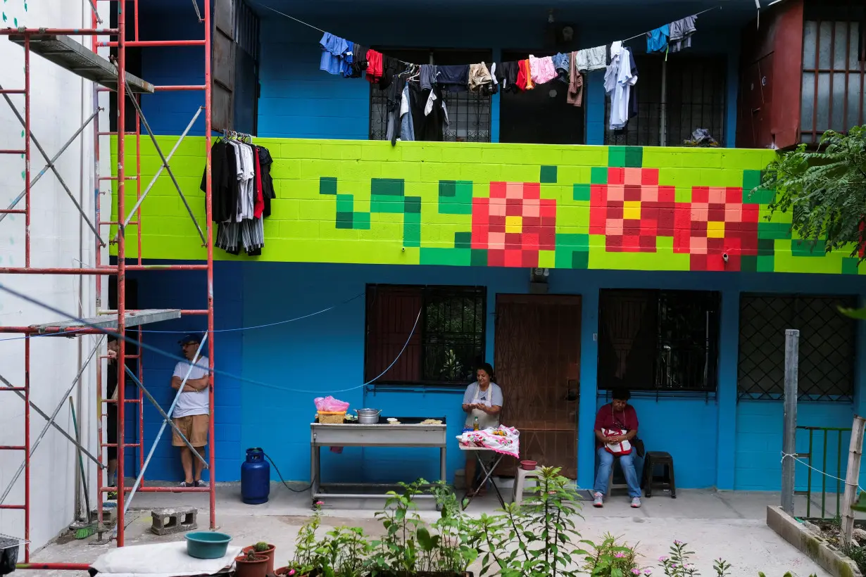 El Salvador muralists paint over traces of violence in San Salvador neighborhood