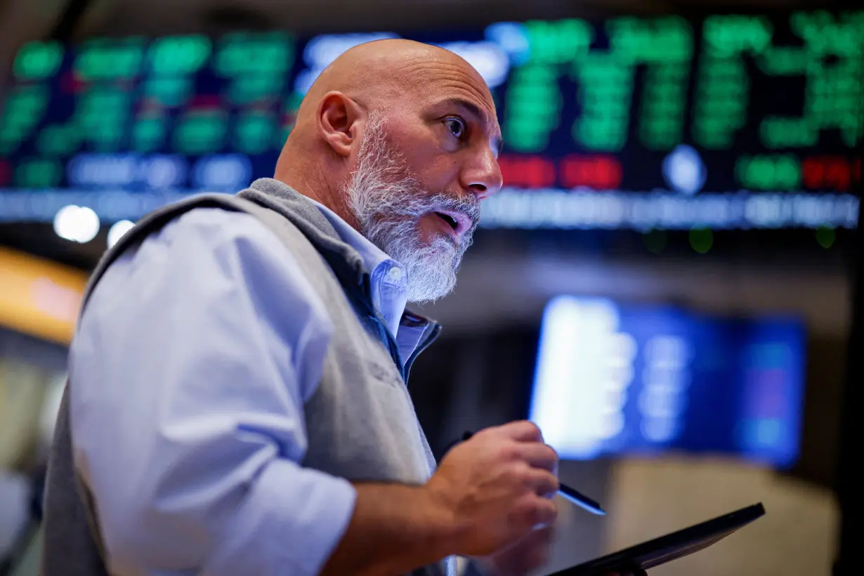 Traders work on the floor of the NYSE in New York