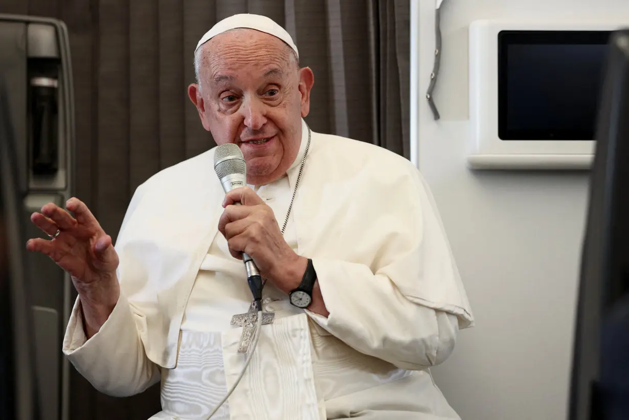 Pope Francis holds a news conference aboard the papal plane