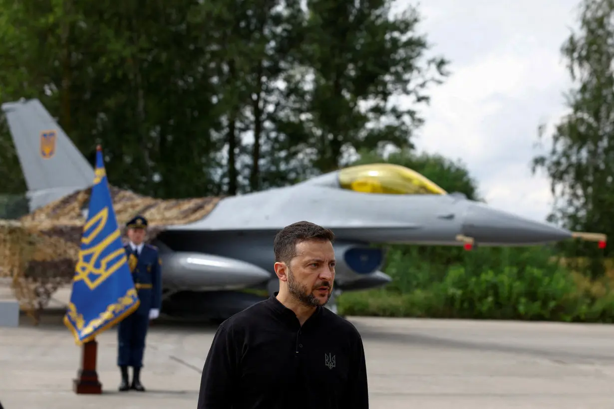 FILE PHOTO: Ukraine's President Zelenskiy speaks to the media in a front of an F-16 fighter jet on the Day of the Ukrainian Air Forces at an undisclosed location in Ukraine