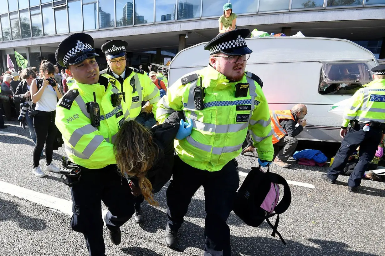 London Metropolitan Police officers arrest an Extinction Rebellion protest during the group's first mass civil disobedience campaign that brought parts of London to a standstill in October 2019. Over the course of that two week protest, Met Police arrested over 1,800 people.